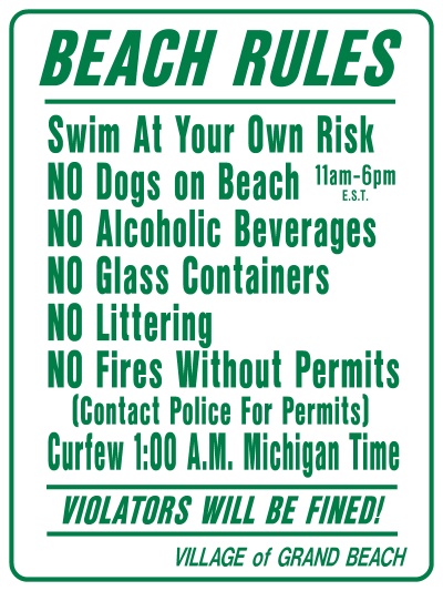 This is a picture of a sign with the beach rules for Grand Beach.